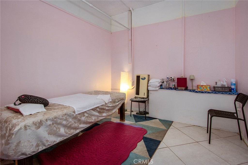 5929 Adobe Road Twentynine Palms, CA 92277 - Photo 9 of 33 a bedroom with a bed a desk and chair