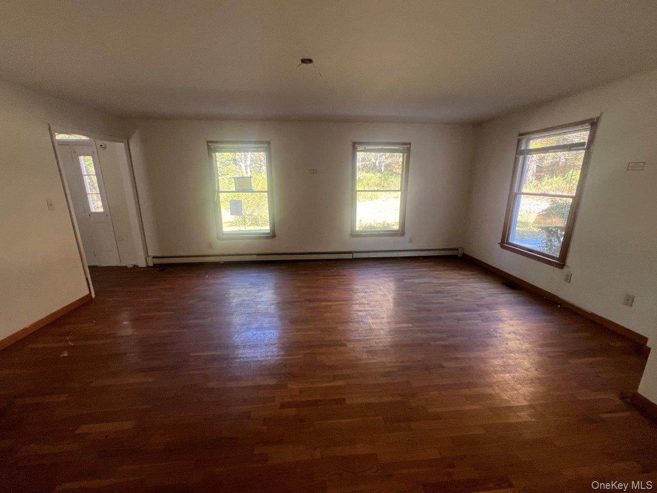 7 Felter Hill Road Monroe, NY 10950 - Photo 9 of 12 Unfurnished room with dark wood-type flooring and a baseboard heating unit