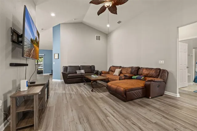 a kitchen with stainless steel appliances kitchen island granite countertop a refrigerator a stove top oven and a sink with granite countertops