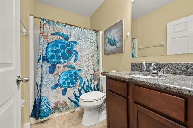 a view of a house with a yard and tree