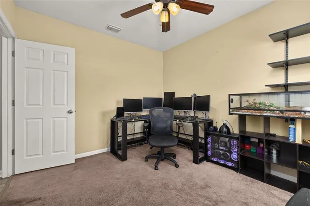 a view of a house with backyard and a tree