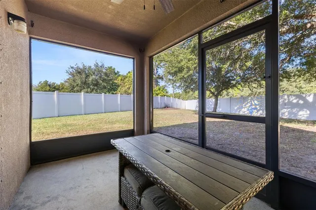 a tree in front of a white house