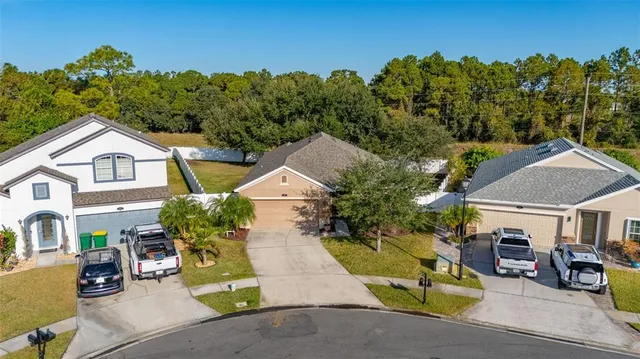 an aerial view of a house with a swimming pool