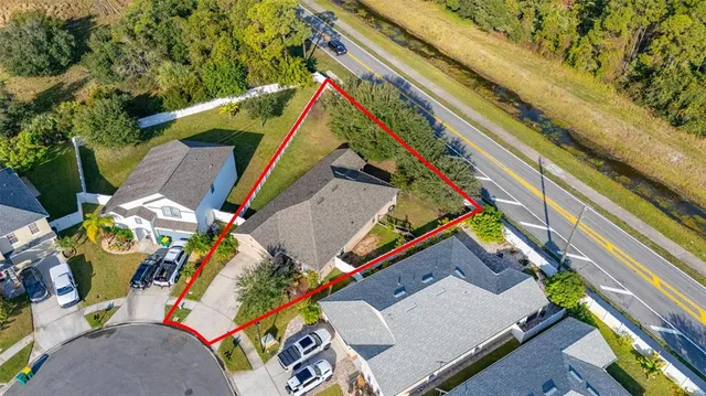an aerial view of a house with a ocean view
