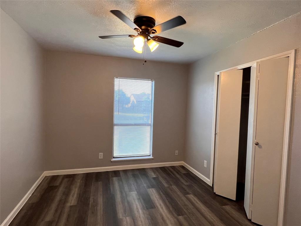 8506 Woodside Road Rowlett, TX 75088 - Photo 17 of 27 wooden floor in an empty room with a window