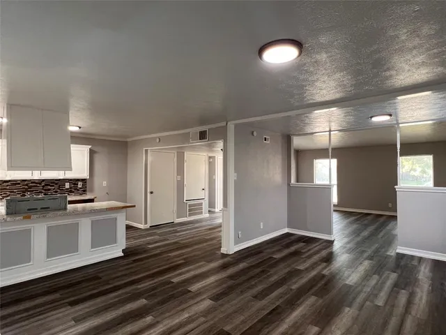 a view of a kitchen with a sink cabinets and wooden floor