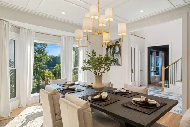 a kitchen with a table chairs sink and cabinets