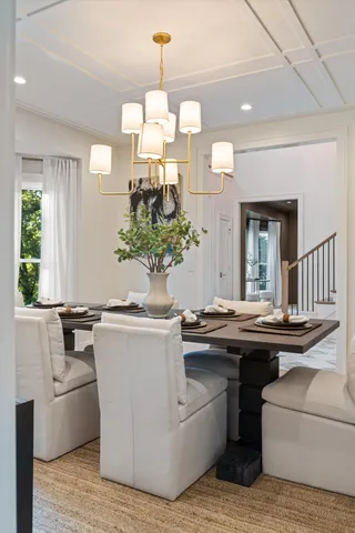 a kitchen with a table chairs sink and cabinets