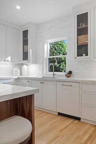 a bathroom with a double vanity sink and mirror with shower