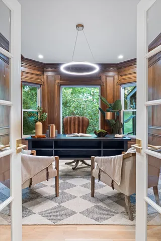 a view of empty room with wooden floor