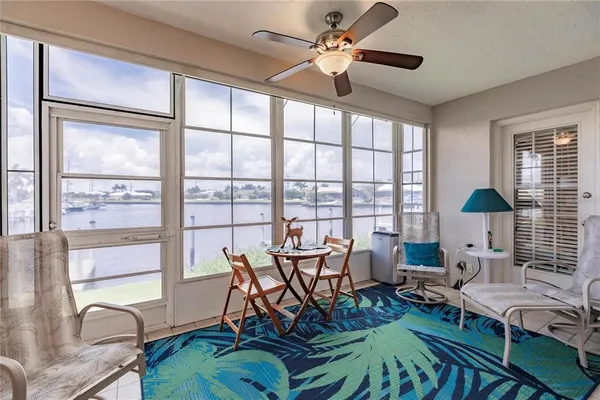 a work room with furniture and floor to ceiling windows