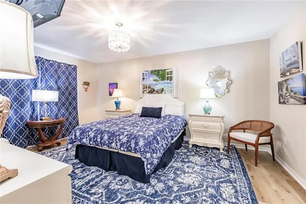 a bedroom with a bed a table and chair
