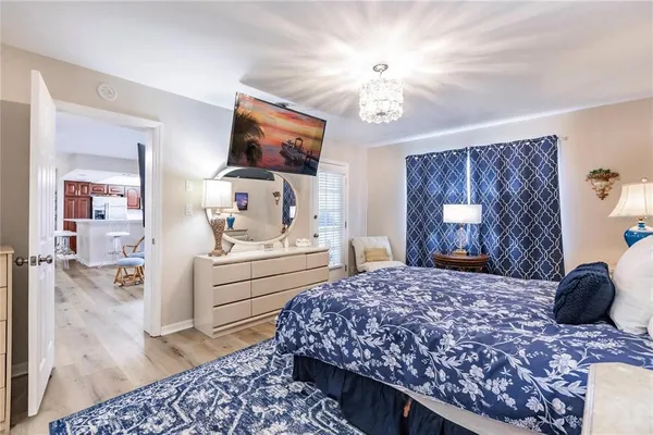 a bedroom with a bed and a chandelier