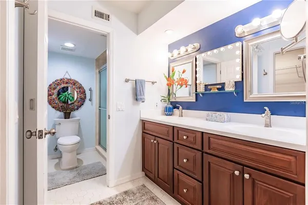 a spacious bathroom with a sink a toilet and a mirror