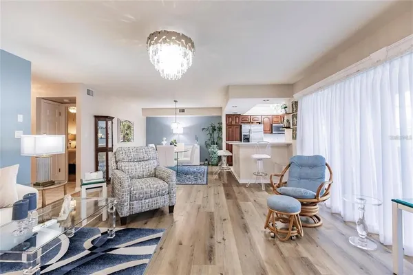 a living room with furniture and a chandelier