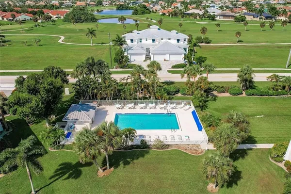 an aerial view of a house with a yard swimming pool and outdoor seating