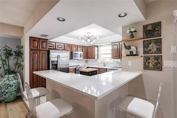 a kitchen with a table a sink and chairs