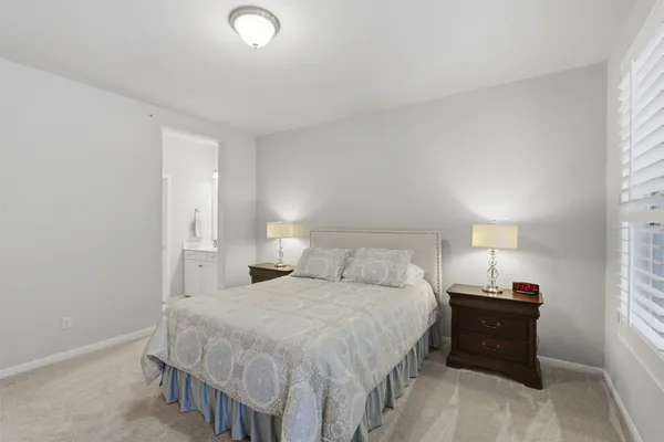 a bedroom with a bed and a lamp