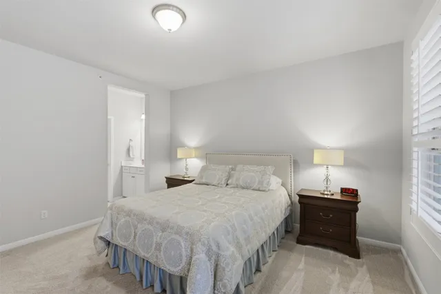 a bedroom with a bed and a lamp