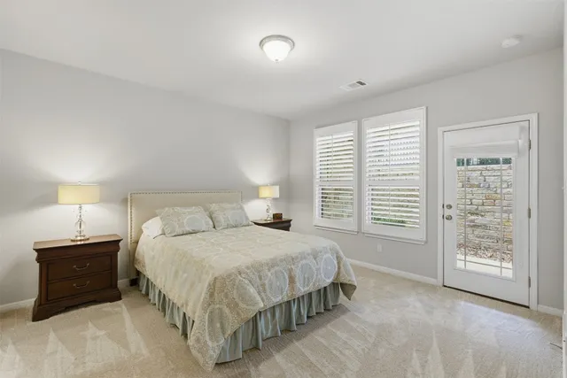 a bedroom with a bed and a lamp