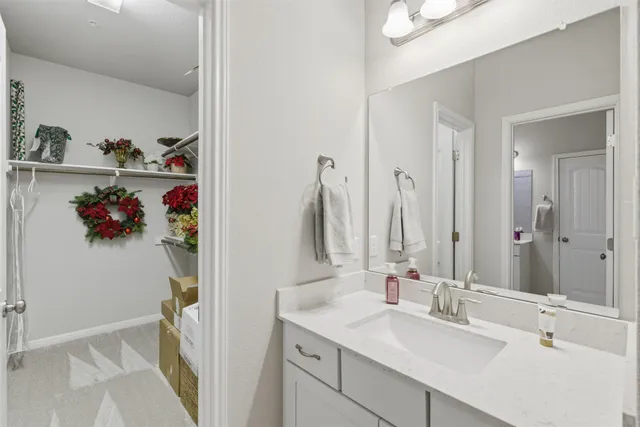 a bathroom with a sink vanity and a mirror