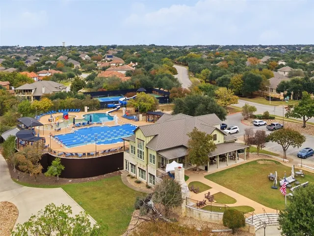 an aerial view of a house with a swimming pool outdoor seating and yard