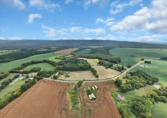 an aerial view of a house with a yard