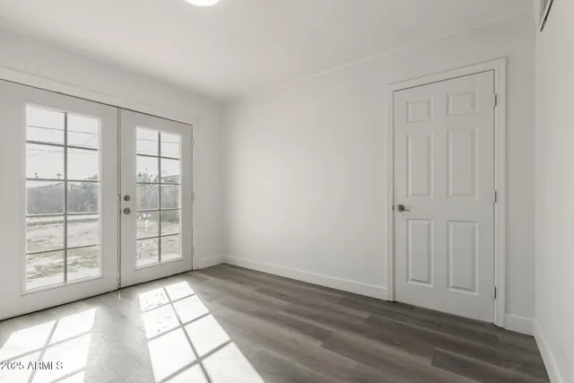 a view of an empty room with glass door