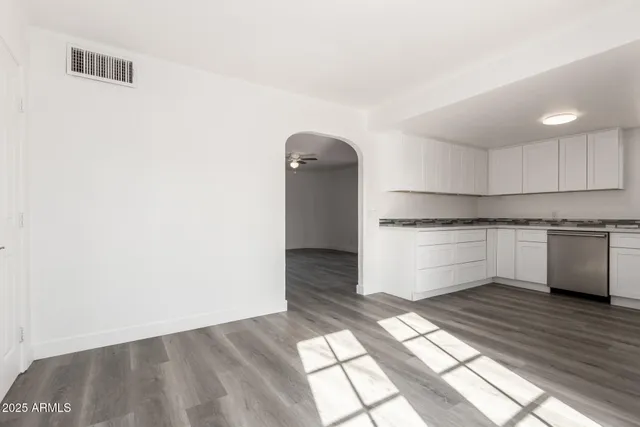 a kitchen with granite countertop white cabinets and white appliances