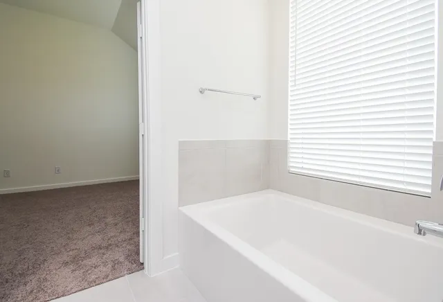 a white bath tub sitting in a bathroom