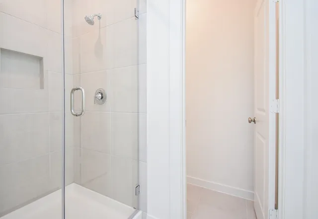 a bathroom with a glass shower door