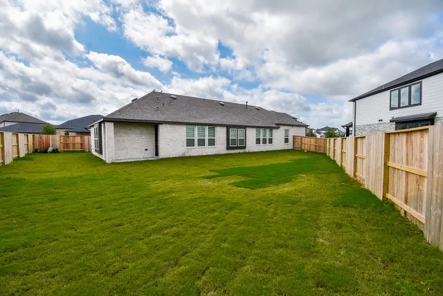 a view of a house with a yard and sitting area