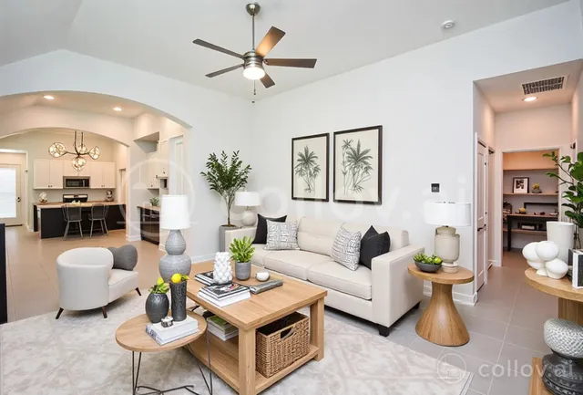 a living room with furniture a rug and a chandelier
