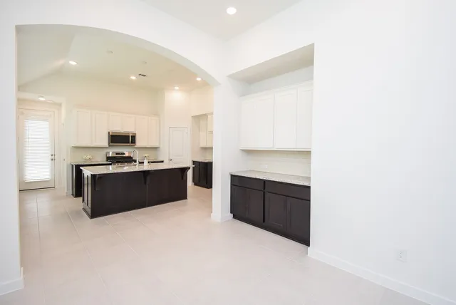 a large kitchen with a sink and cabinets