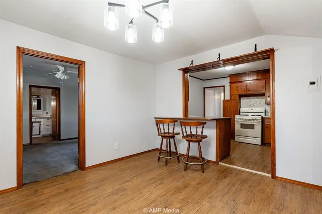 a view of a room with furniture and wooden floor