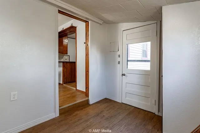 a view of empty room with wooden floor