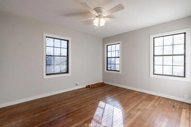 wooden floor in an empty room with a window