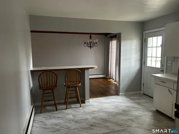 a dining room with furniture and window