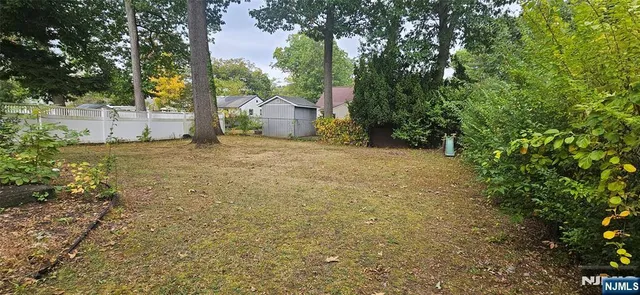 a big yard with trees in the background