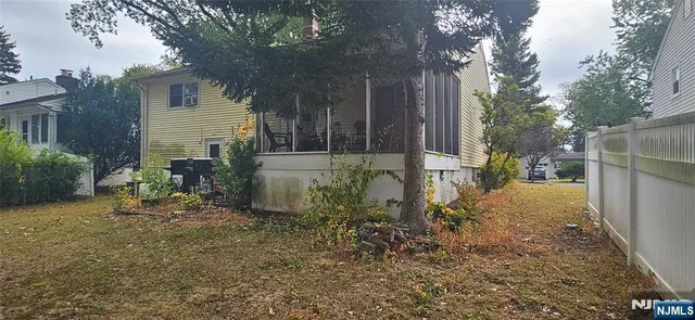 a backyard of a house with table and chairs