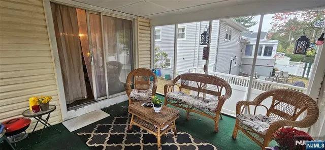 a view of an chairs and tables in the balcony