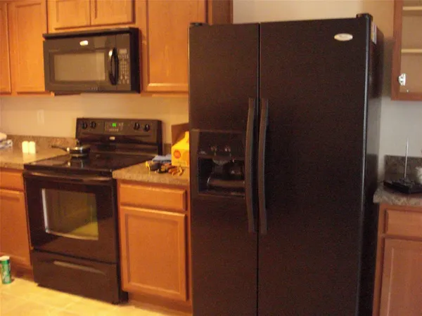 a kitchen with a refrigerator and cabinets
