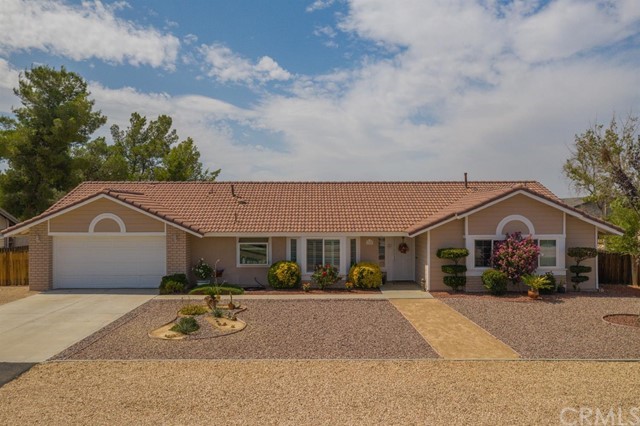 13492 Coachella Road Apple Valley, CA 92308 - Photo 1 of 1 a front view of a house with a yard and car parked