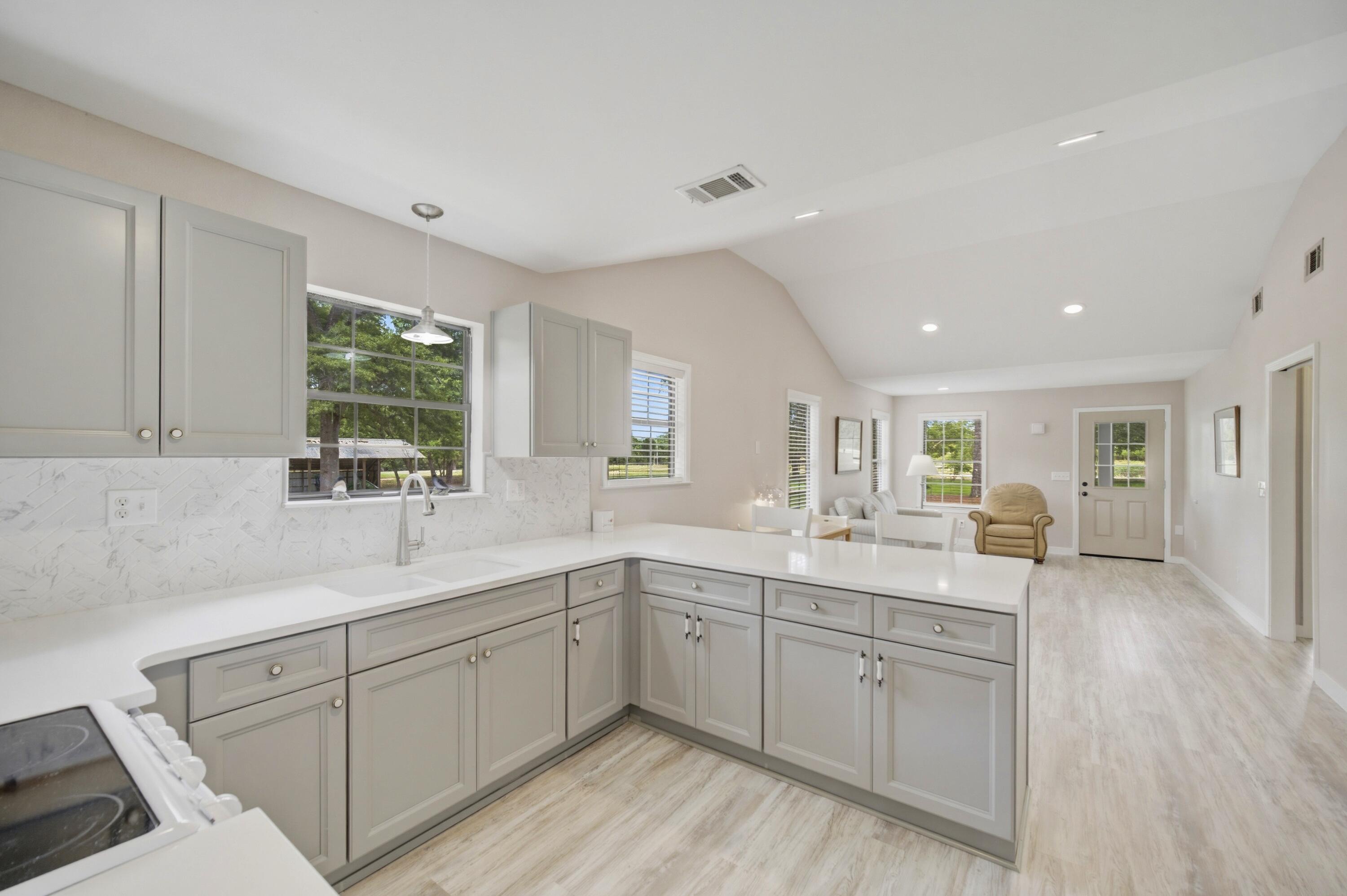 261 Wilkerson Road DeFuniak Springs, FL 32433 - Photo 55 of 76 a kitchen with sink stove and cabinets
