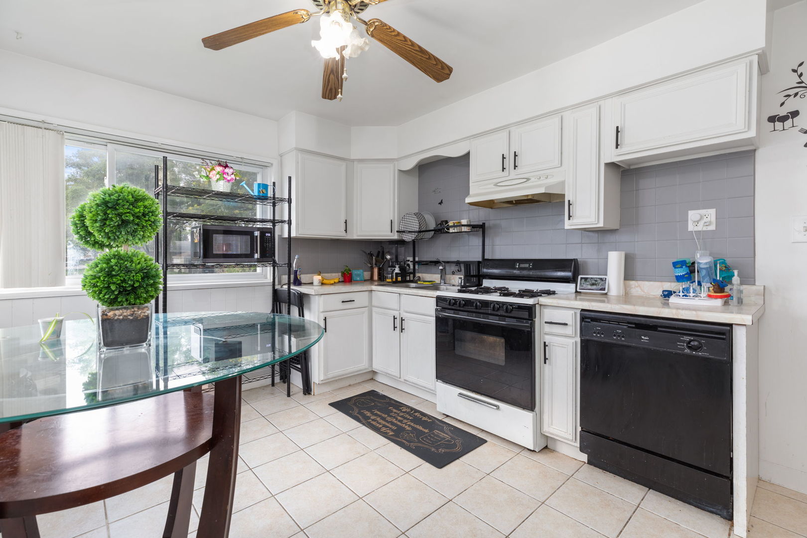 4719 Butterfield Road Hillside, IL 60162 - Photo 4 of 15 a kitchen with stainless steel appliances granite countertop a stove sink and cabinets