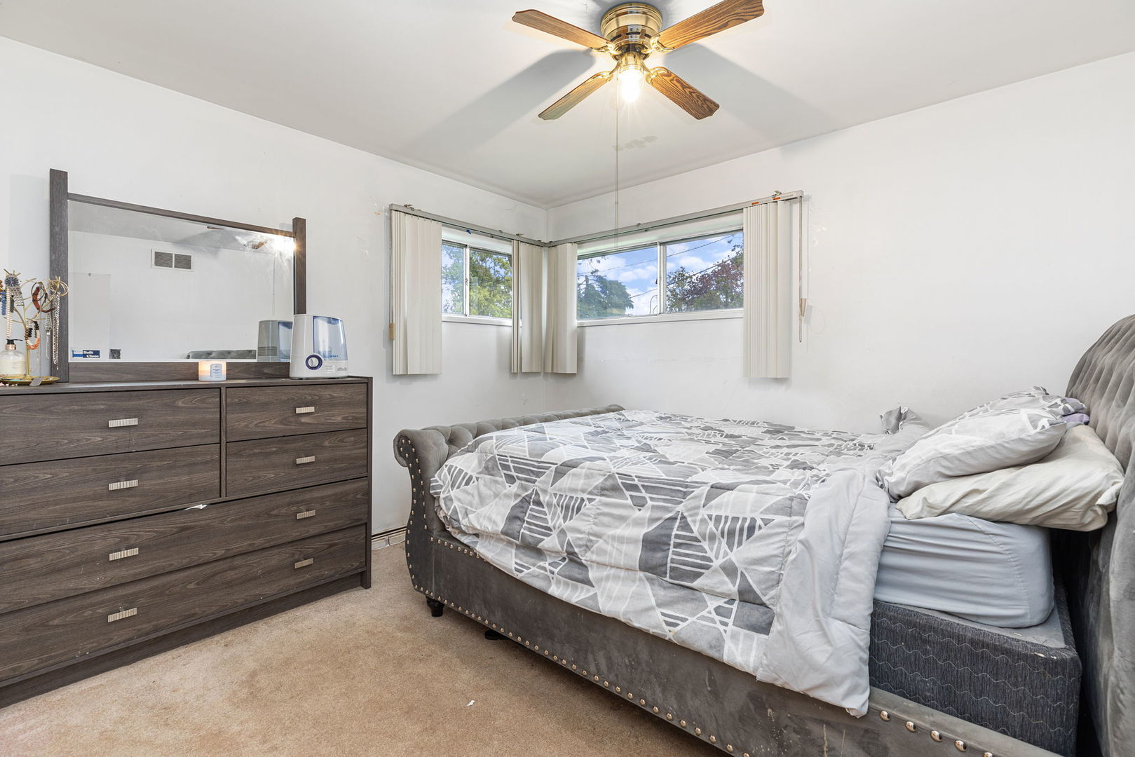 4719 Butterfield Road Hillside, IL 60162 - Photo 8 of 15 a bedroom with a bed and a mirror on the dresser