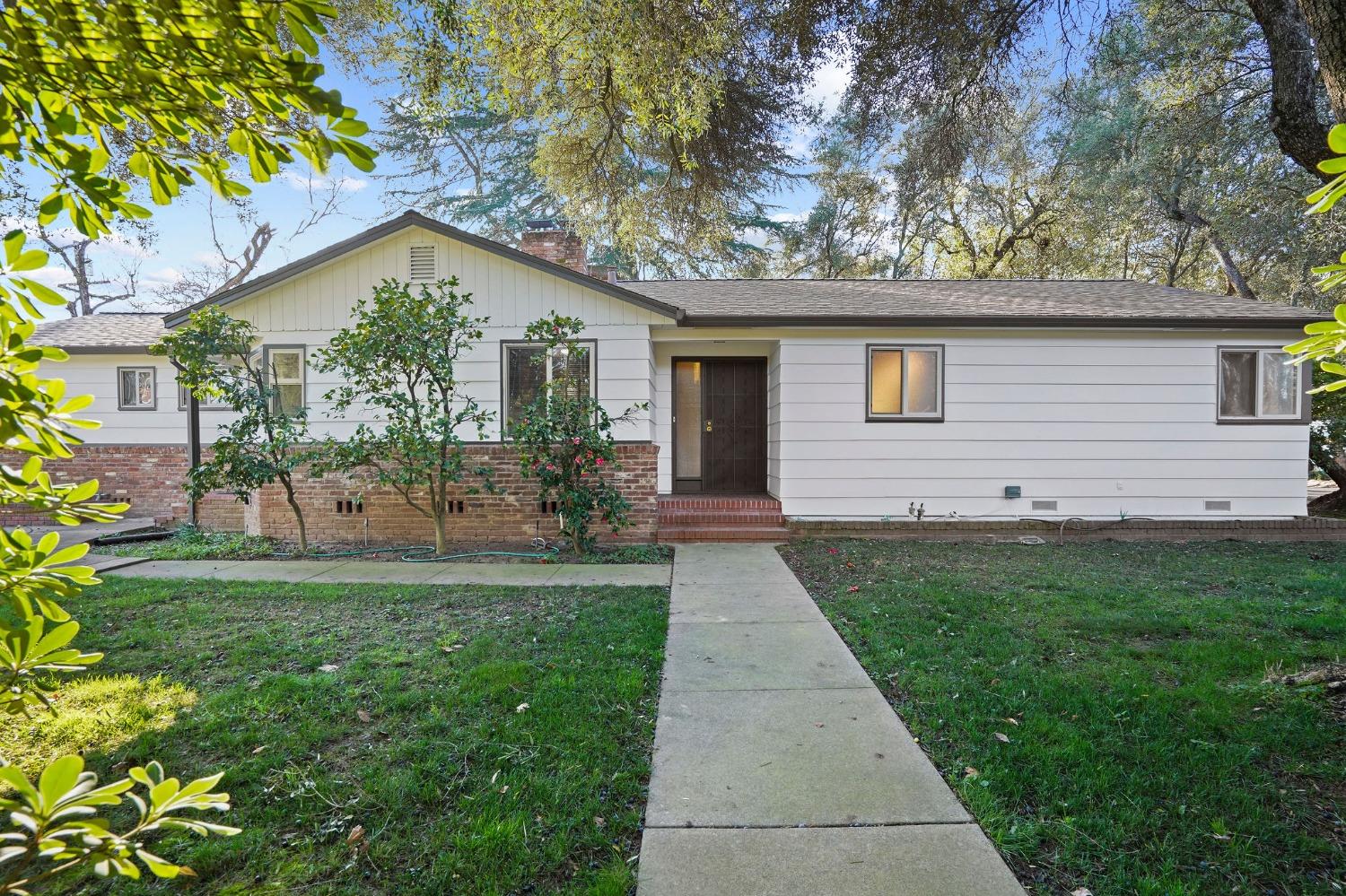 a backyard of a house with table and chairs