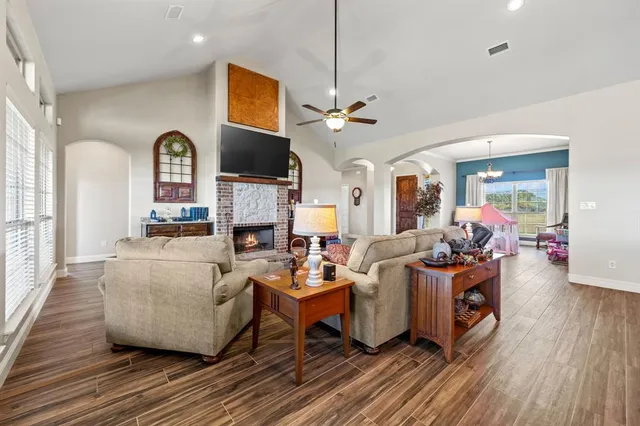 a living room with fireplace furniture and a flat screen tv