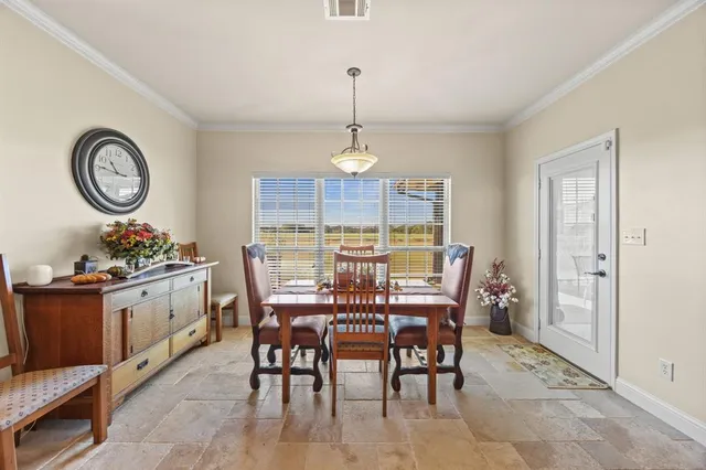 a view of a dining room and livingroom with furniture window and wooden floor