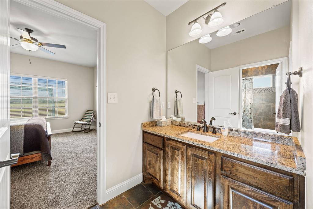 454 Farr Altom Road Seagoville, TX 75159 - Photo 22 of 29 a bathroom with double vanity sinks a vanity a lamp and a mirror